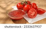 Tomato puree in a bowl with tomatoes on a cutting board. red vegetable sauce. food preparation. Dolly shot. High quality 4k footage