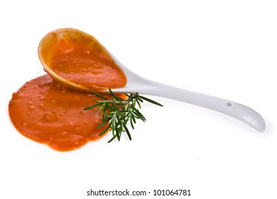 Tomato  Puree The Soup Spilled From A White Spoon Isolated On White Background