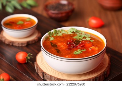 Tomato rasam curry hot spicy soup South Indian cuisine prepared using Indian spices, tomato tamarind , chili, cumin. Traditional vegetarian dish rice onam sadhya Kerala, Tamil Nadu, India Sri Lanka.