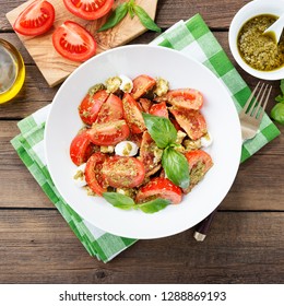 Tomato salad with basil,mozzarella cheese and pesto sauce . - Shutterstock ID 1288869193