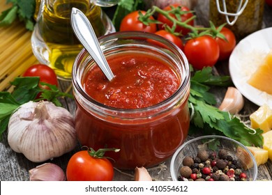 tomato sauce in a glass jar and ingredients, closeup, horizontal