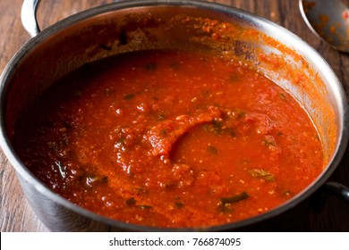 Tomato Sauce With Herbs In Metal Pot