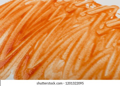 Tomato Sauce Lines Or Marinara Texture On White Background. Smeared Tomato Dressing Or Ketchup Top View