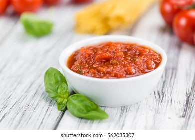 Tomato Sauce on a vintage background as detailed close-up shot (selective focus)