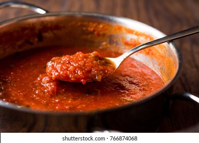 Tomatensauce mit Löffel auf Metallplatten