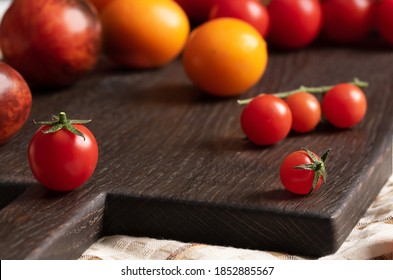 Tomato With Sepal And Pedicel. Cherry Tomatoes On A Background Of Large Tomatoes