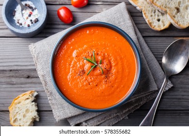 Tomato Soup In A Black Bowl On Wooden Background. Top View. Copy Space