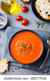 Tomato Soup In A Black Bowl On Grey Stone Background. Top View. Copy Space.