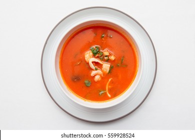 Tomato Soup With Fish And Shellfish On White Table Cloth, Shot From Above