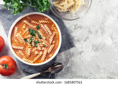 Tomato Soup With Fusilli Pasta In The Bowl On A Bright Background