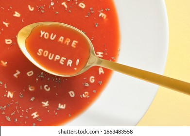 Tomato Soup With Letter Noodles On Spoon