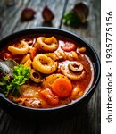 Tomato soup with noodles on wooden table 