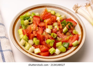 Tomato And Spring Onion Relish In Lemon Juice In A China Bowl, White Background.