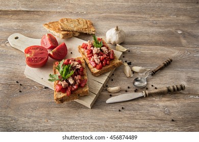 Tomato And Tuna Bruschetta On Rustic, Old Wood Background