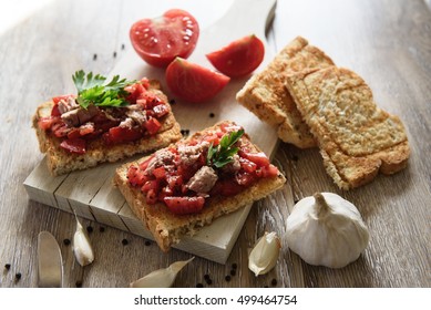 Tomato And Tuna Bruschetta On Rustic, Old Wood Background