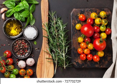 Tomatoes, basil and spices on stone table. Cooking concept. Top view - Shutterstock ID 727732729