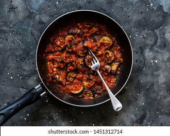 Tomatoes Eggplant Pasta Sauce In A Pan On A Dark Background, Top View  