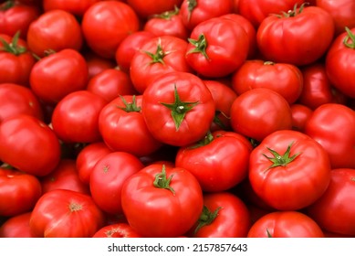 Tomatoes lying on a pile on top of each other, tomato texture. Selective focus. - Shutterstock ID 2157857643