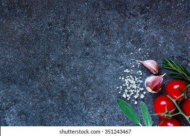 Tomatoes With Sea Salt, Garlic Cloves And Fresh Herbs On Dark Slate Background. Organic Vegetables. Cooking, Healthy Eating Or Vegetarian Concept. Top View.