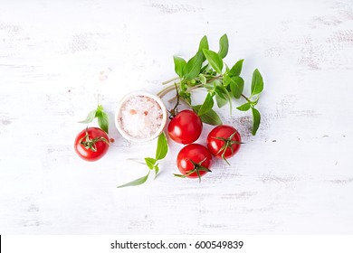Tomatoes, Thai Basil and Himalayan Salt; symbolic image. Concept for healthy nutrition. White wooden background. Top view. Copy space.  - Shutterstock ID 600549839
