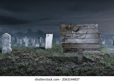 Tombstones on the graveyard with empty wooden plank and night scene background. Halloween concept