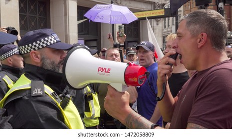 A Tommy Robinson supporter shouts at police along Oxford Street in London, UK, 03/08/19