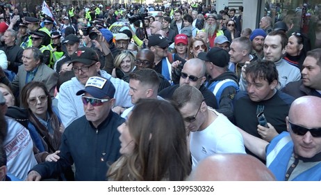 Tommy Robinson walks with a crowd of supporters and media as he leaves his trial at the Old Bailey, London, UK 05/14/19