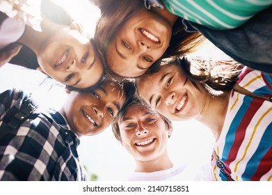 Tomorrow Belongs To Us. Low Angle Portrait Of A Group Of Diverse Schoolchildren Standing In A Huddle.