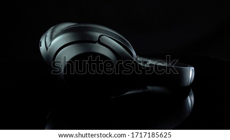 TOMSK, RUSSIA - April 12, 2020: Sony WH-1000XM3 Noise Canceling Wireless Headphones on a rotation platform black background. lies