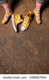 TONDANO, INDONESIA - MAY 26th, 2021 Yellow Converse Shoes And Foot Wearing Socks In A Portrait Picture