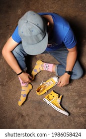 TONDANO, INDONESIA - MAY 26th, 2021 A Man Wearing Yellow Socks, And Yellow Converse Shoes