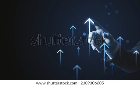 Toned businessman hands pointing at growing upward arrows on dark background. Company growth and increase concept