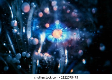 Toned composition of ice bubbles in the thickness of the ice. Colored background. The concept of subatomic particles or cosmic bodies. Abstract image. Selective focus.