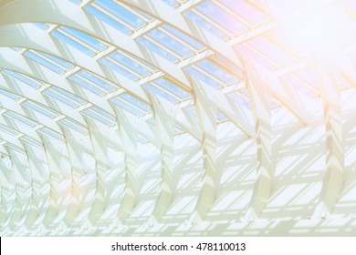 toned photo bearing structure of the glass cover of the building under the blue clear sky