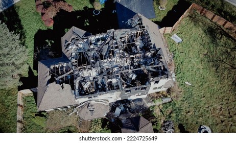 Toned photo burnt house with destroyed single roof of two story single family home in Rochester, New York, USA. Residential property totally damaged by fire disaster, insurance claim background