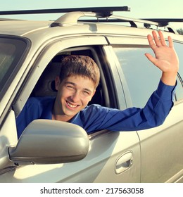 Toned Photo Of Happy Teenager Sitting In The Car And Wave Goodbye