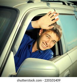 Toned Photo Of Happy Teenager Sitting In The Car And Wave Goodbye