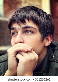Toned Photo of Sad Young Man Portrait outdoor
