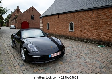 Tongerlo, Antwerp Belgium - April 28 2022: Just Married Couple In A Black Porsche Convertible Ready For A Photo Session In The Tongerlo Abbey.
