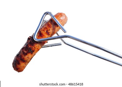 Tongs Holding a Grilled Bratwurst Isolated on White