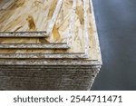 Tongue and groove oriented strand board. Stacked OSB sheets. Sheet material for construction and repair.                               