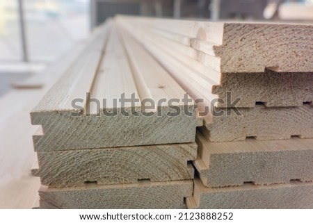 Tongue and groove wooden boards storage. Batten boards with grooves and tongues in market warehouse [[stock_photo]] © 