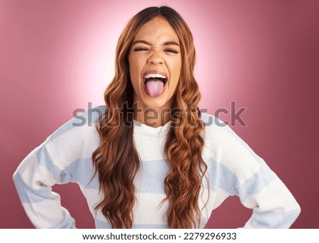 Tongue out, silly and face of woman in studio for , goofy and funny expression isolated on red background. Happiness, comic and smiling with female and fun gesture for confidence, cool and joy