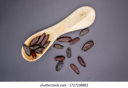 Tonka Beans Isolated With Wooden Spoon, Seads From Dipteryx Odorata Tree Used In Modern Cuisine