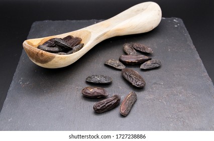 Tonka Beans Isolated With Wooden Spoon, Seads From Dipteryx Odorata Tree Used In Modern Cuisine