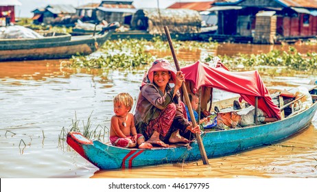 Tonle Sap Lake Siem Reap, Cambodia - July 13, 2013: Cambodian People Live On Tonle Sap Lake In Siem Reap, Cambodia. Mother With The Children In The Boat