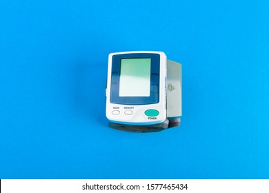 Tonometer For Pressure. Electronic Portable Blood Pressure Monitor. View From Above. On A Blue Background.