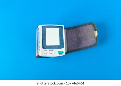 Tonometer For Pressure. Electronic Portable Blood Pressure Monitor. View From Above. On A Blue Background.