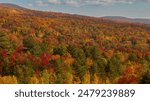 Tons of Fall Colors Dot the Vermont Mountainside. Overlooking the other mountains, all you can see during peak fall foliage in Vermont is a sea of colors all blending together  