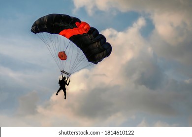 Tonsai Beach, Krabi Province, Thailand - 22d December, 2019: Base Jumping In Thailand. The Parachute And The Silhouette Of The Base Jumper Against The Sunset Sky. 